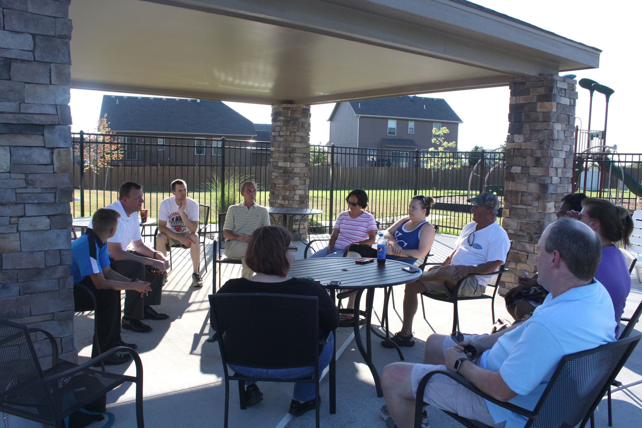 Mayor Steve Ellis sits in a circle with Spring Hill residents outside during a previous Walk and Tal